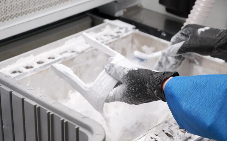 An Extol application engineer depowdering a bespoke brace